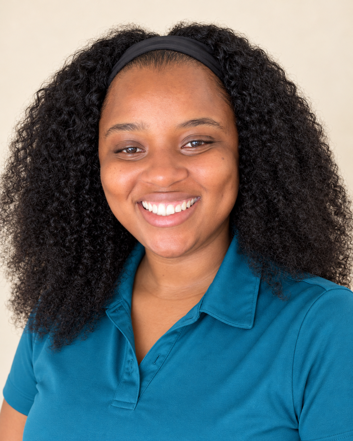 Francy Forbes, founder of Your Island Host, smiling in a teal shirt
